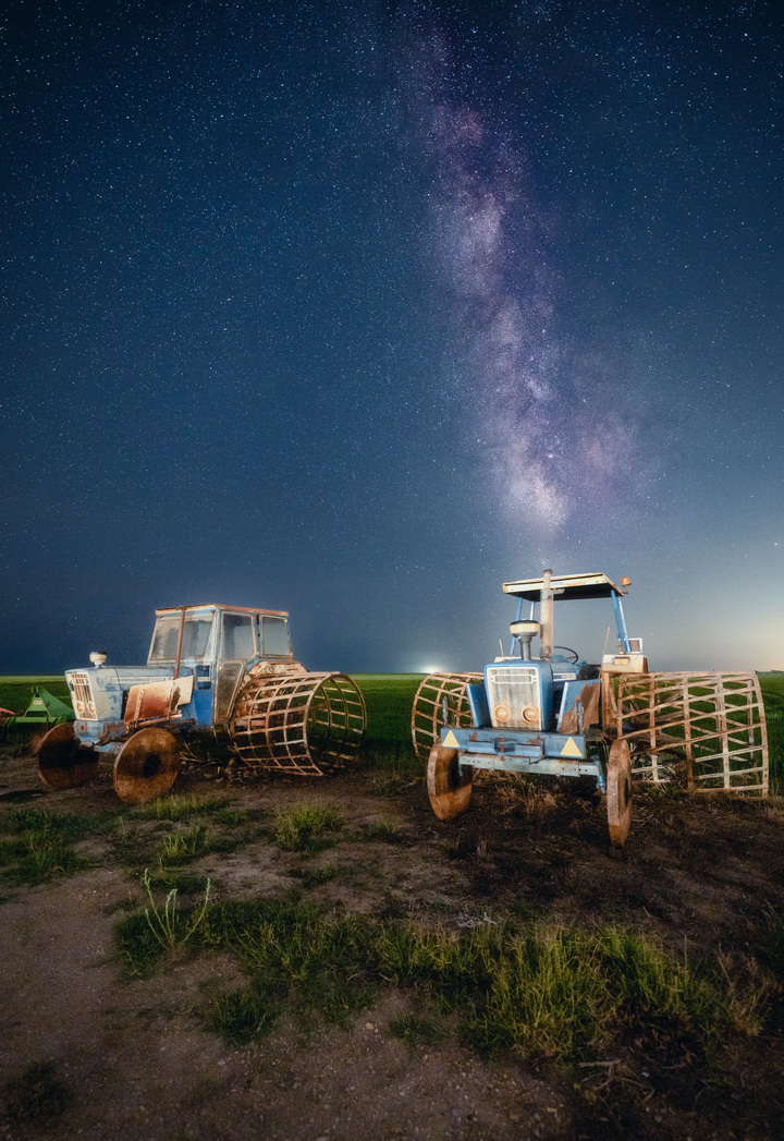 Rusty tractors beneath the starry night