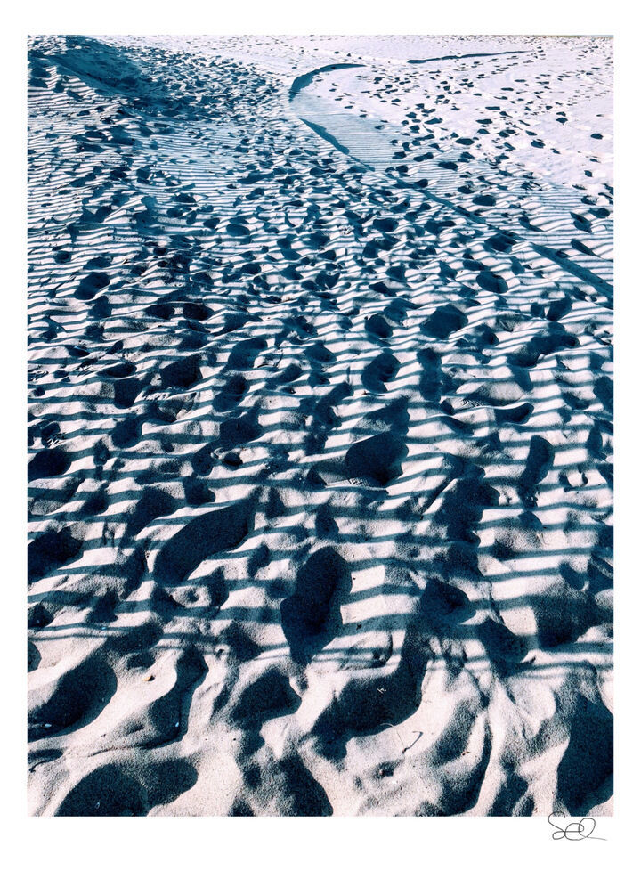 Footprints And Shadows In The Sand