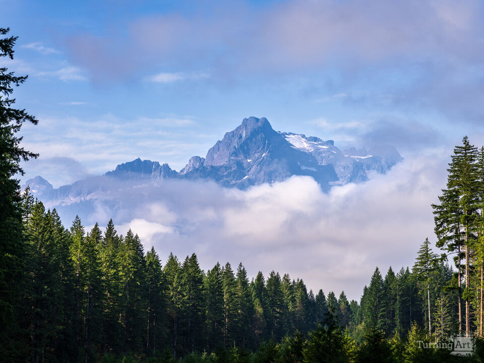 Whitehorse Mountain appears through the clouds