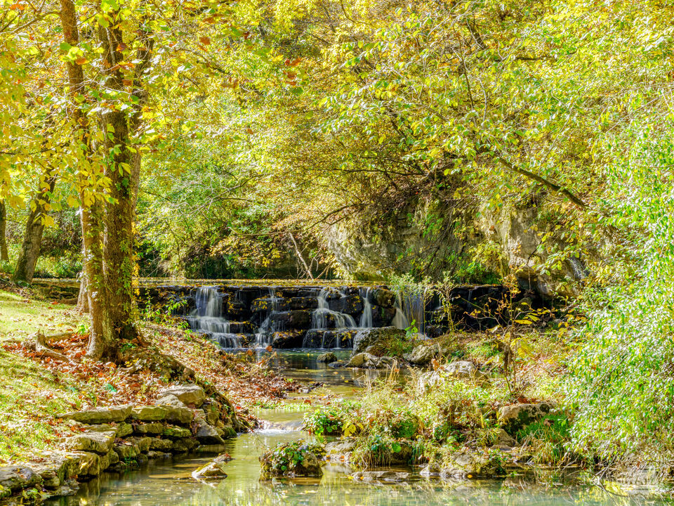 Autumn Glow Over A Waterfall