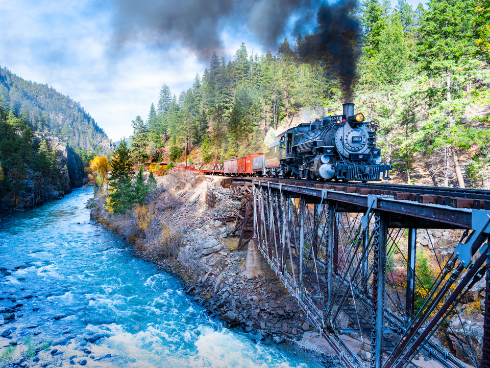 Steam Locomotive crosses trestle above Animus R.