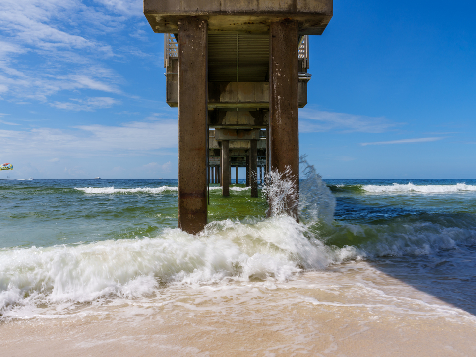 Crashing Waves Under Orange Beach Pier
