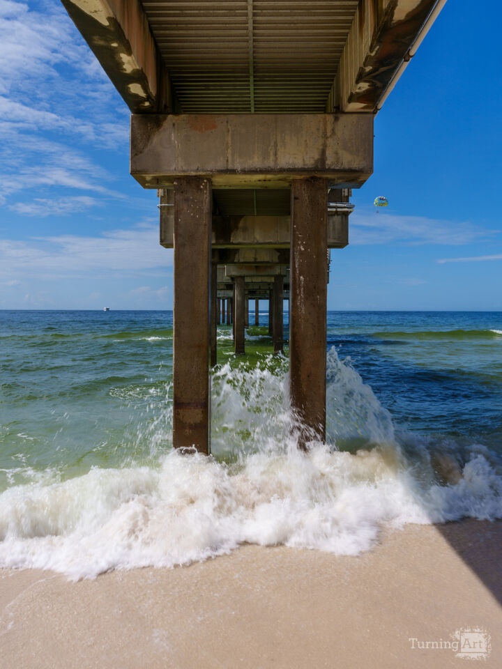 Splashing Waves Under Orange Beach Pier