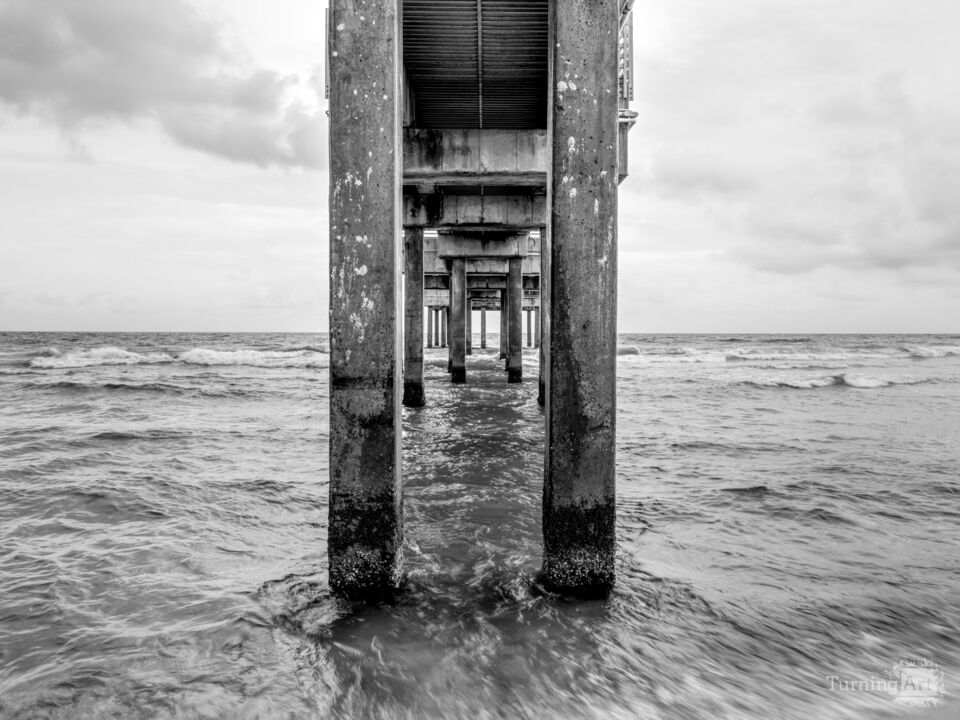 Quiet Tides Under Orange Beach Pier Grayscale