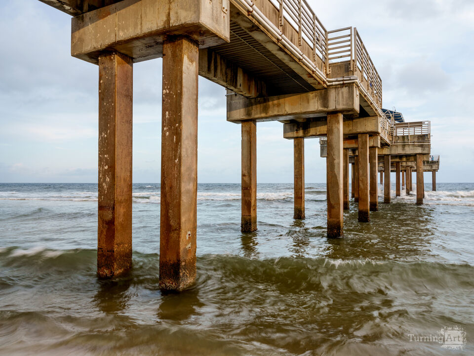 Rolling Waves Under Orange Beach Pier