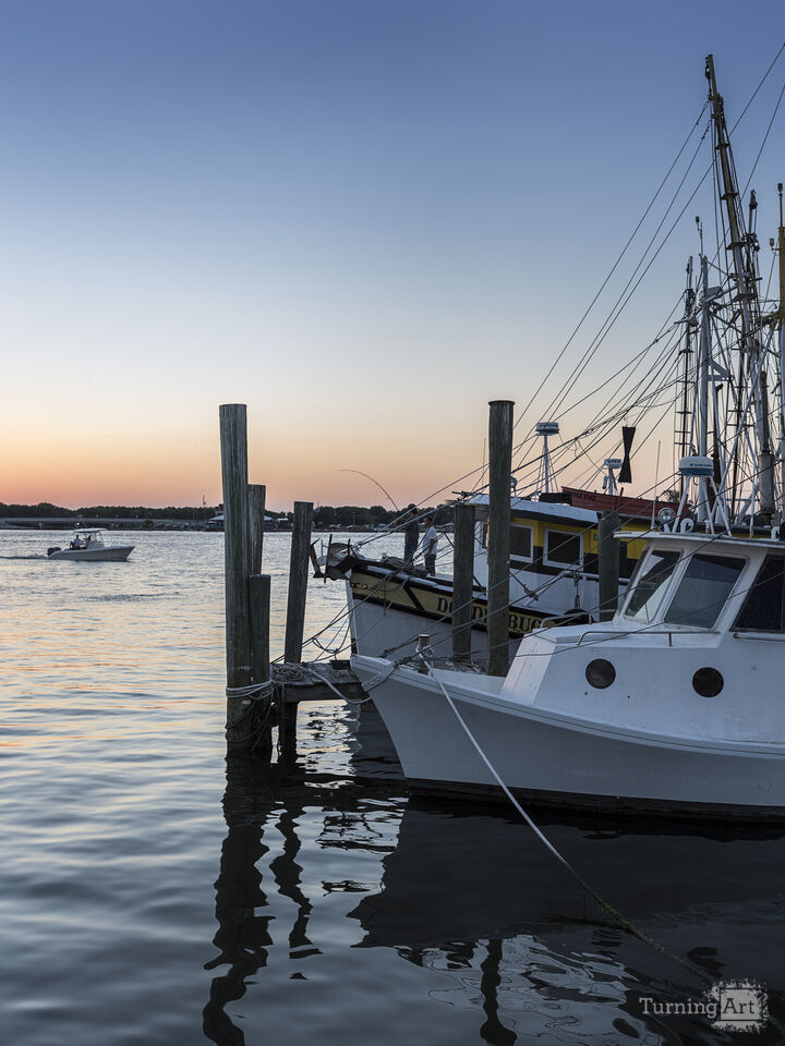 Boats and kayaks against a blue sky