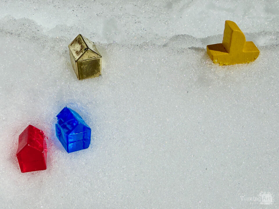 Toy Houses and Sailboat in Snow