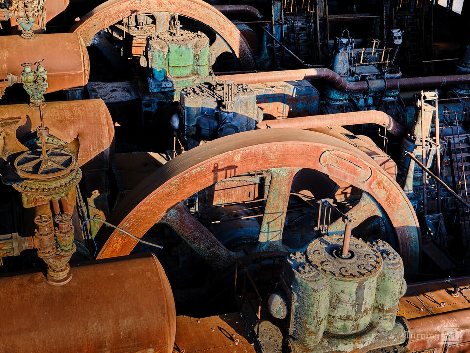 Flywheels, Gears, and Rust at Sunset