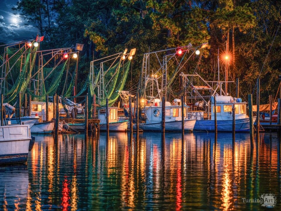 Coastal Fishing Boats at Night with Glowing Harbor