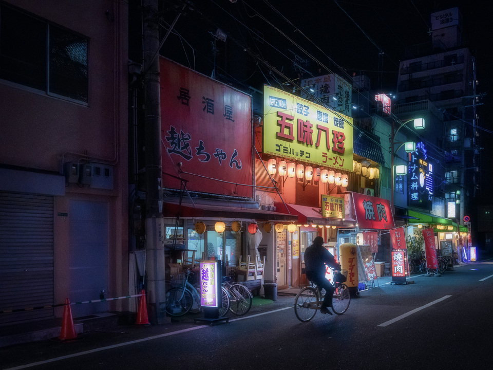 Cyclist Under Neon