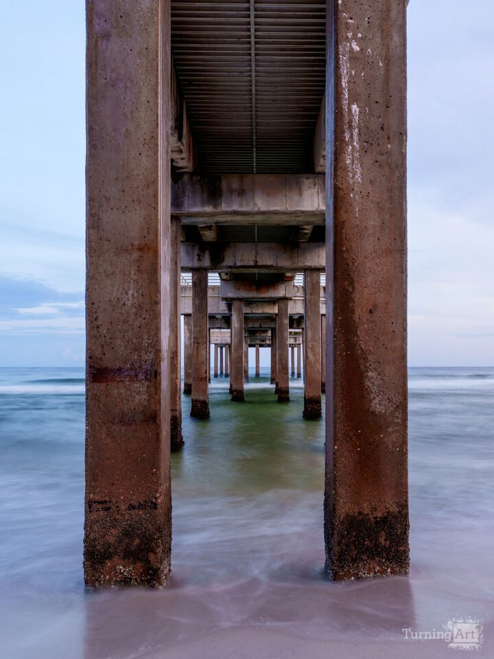 Blushing Dusk Under Orange Beach Pier