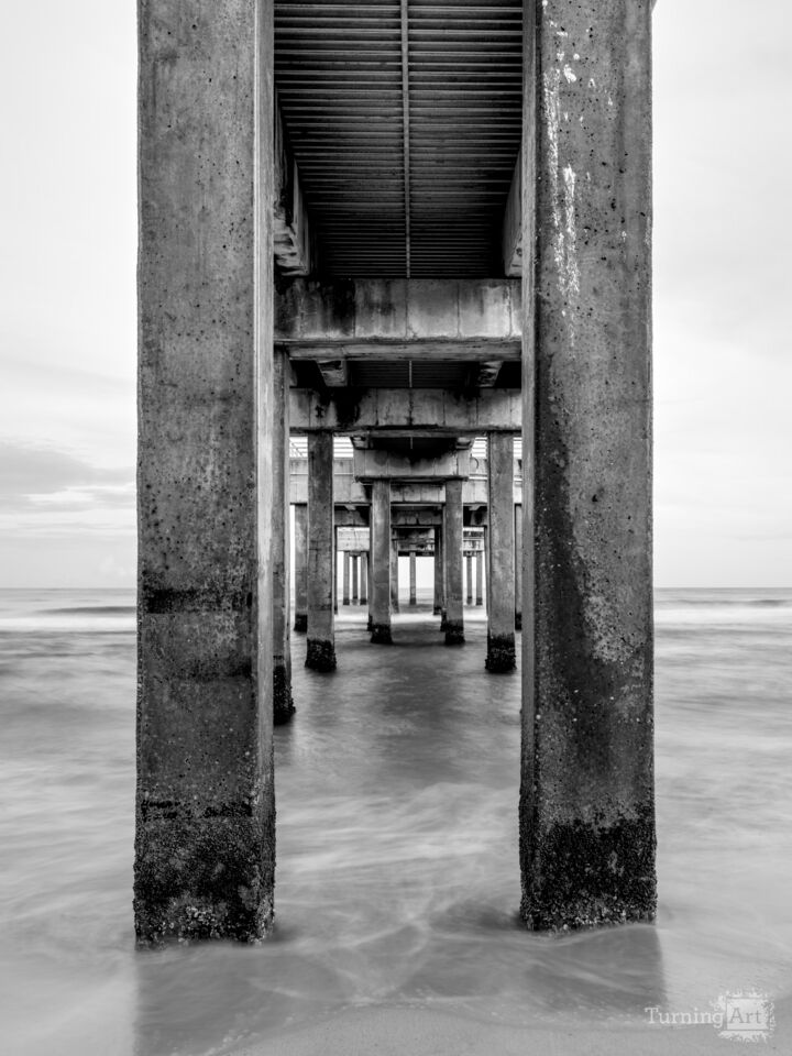 Blushing Dusk Under Orange Beach Pier Grayscale