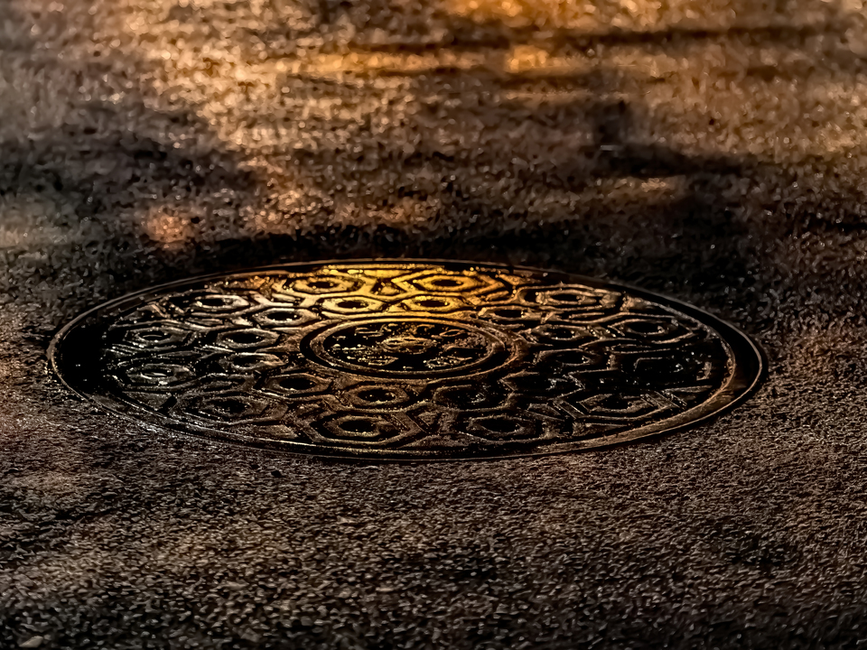 Manhole Cover Wet Street at Night