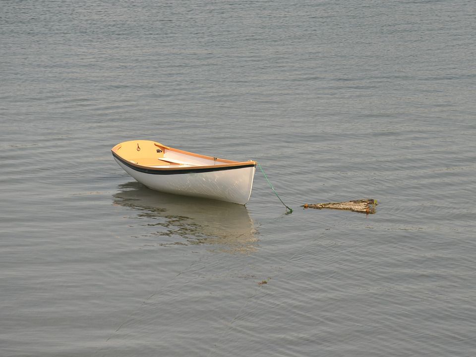 White and Teak Rowboat moored in Maine