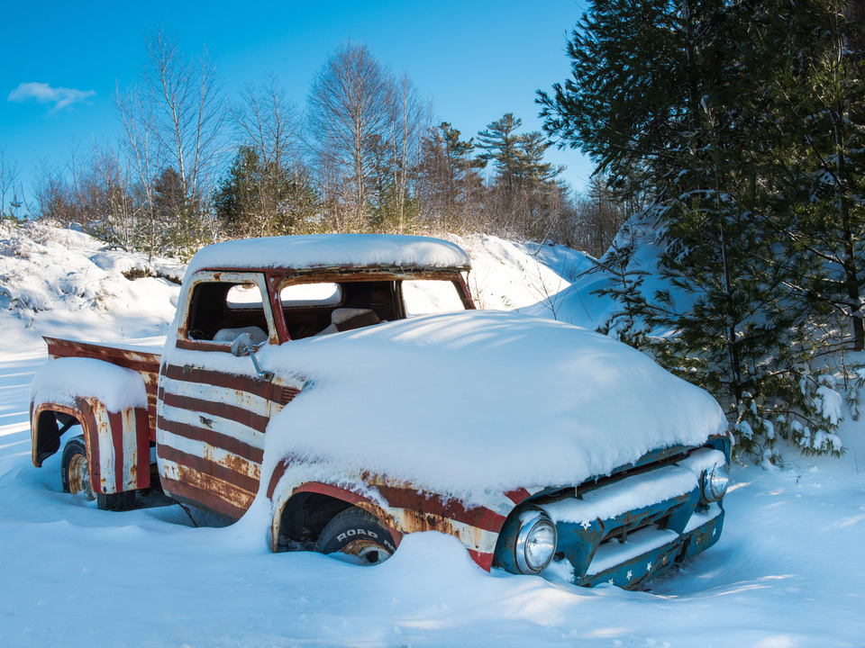 Red, White and Blue Pickup Truck in Snow