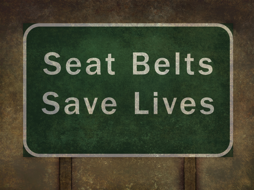"Seat belts save lives" roadside sign 